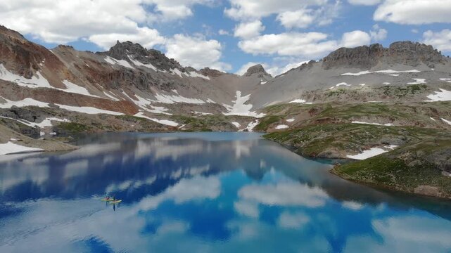 Paddle boarders with dog on a high alpine lake in Colorado