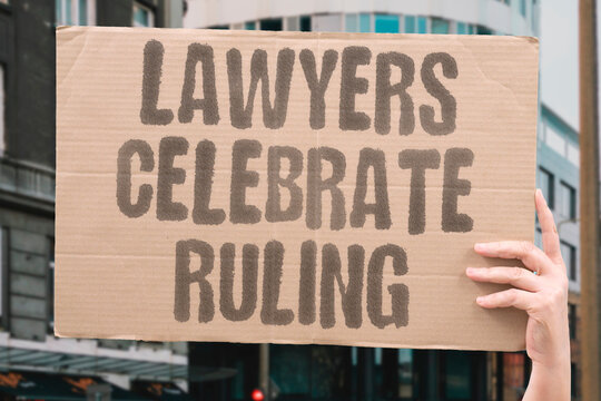 "Lawyers celebrate ruling" Legal teams cheer a court decision that keeps their case alive. LAWYERS. RULING. CELEBRATION. COURT. LAWSUIT.