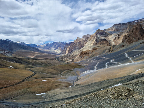 View of the winding Penzi La road through the rugged, mountainous landscape of the Zanskar valley in Zanskar, Ladakh, India.