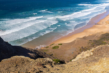 View of a picturesque beach on the Atlantic Ocean, with crashing waves under a blue sky, Sagres Viewpoint, Algarve region, Faro district, Portugal – background or wallpaper  © anettastar