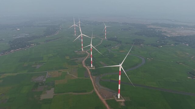 Aerial view of the Cox's Bazar 60 MW Wind Power Plant with wind turbines standing in green fields in Cox's Bazar, Chittagong Division, Bangladesh.