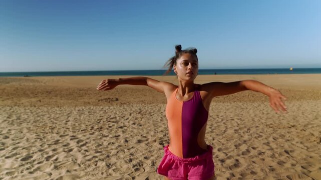 Woman opens arms then leans into beach side stretch