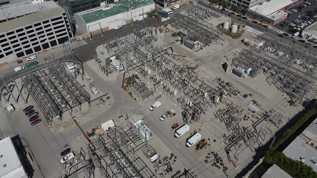 Aerial view of the Department of Water and Power electrical substation with transformers and utility vehicles in Los Angeles, California, United States.