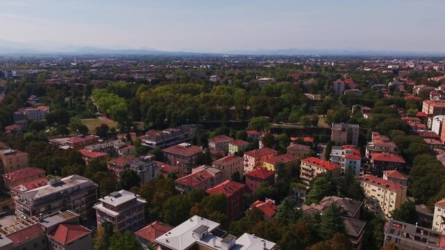 Aerial drone view of Parco della Cittadella in Parma, Italy, showcasing the historic fortress walls, pentagonal park, lush greenery, walking paths, and surrounding cityscape.