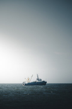 View of a fishing boat sailing on the open sea under a bright sky in Nova, Laane County, Estonia.