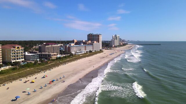  Surf and coastal accommodation lead toward the horizon in this shoreline tracking shot.
