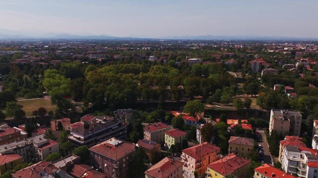 Aerial drone view of Parco della Cittadella in Parma, Italy, showcasing the historic fortress walls, pentagonal park, lush greenery, walking paths, and surrounding cityscape.