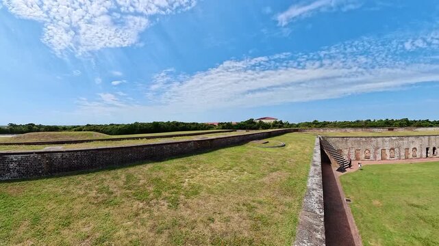 Grassy ramparts border Fort Macon courtyard during a slow rightward panoramic view.