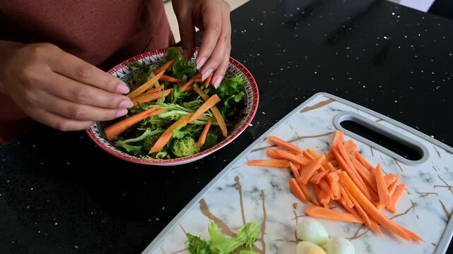 Woman preparing a fresh vegetable salad with quail eggs