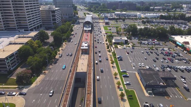  4K drone video pulls back along elevated railway tracks in Tysons, Virginia.
