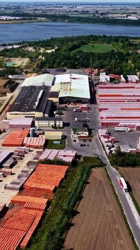 Aerial view of ZE PAK S.A. Elektrownia Patnow power plant facility with industrial buildings, storage yards, and surrounding landscape in Konin, Wielkopolskie, Poland.