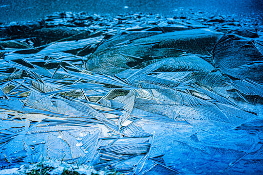 View of intricate ice shards and crystalline patterns forming on a frozen surface in the United Kingdom.