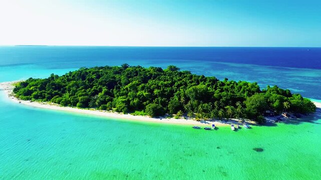 Aerial view of Sangalaki Island with turquoise waters and coral reefs surrounding the tropical island in Berau, East Kalimantan, Indonesia.