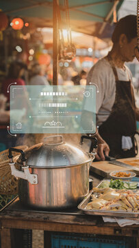 Large stainless steel cooking pot boiling aromatic soup at Thai night market