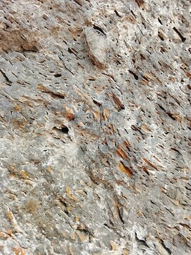 Natural porous stone surface texture background with rough details and crevices