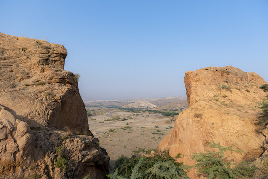 View of the rugged rocky terrain of the Sulaiman Mountains under a clear blue sky in De-excluded Area Dera Ghazi Khan, Punjab, Pakistan.