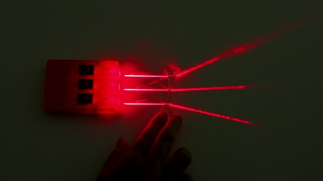 Refraction of Red Laser Beams Through Concave Lens in Physics Experiment
