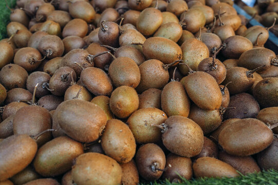 Close-up of fresh kiwi fruits with shallow depth of field for sale at a local market stall