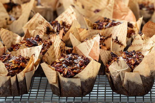 Rows of freshly baked morning glory muffins on a cooling rack.