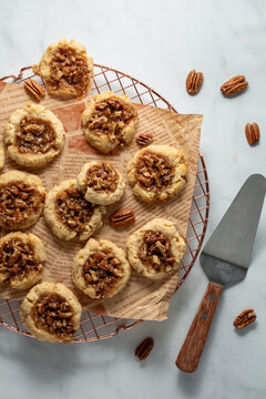 Homemade Pecan Pie Cookies on a parchment paper covered cooling rack.