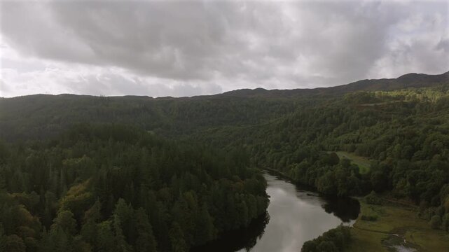 Drone shot of the River Garry, near Pitlochry in Scotland. The scene shows a typical Scottish woodland setting with a river flowing through. Shot in early Autumn the colours are starting to turn.