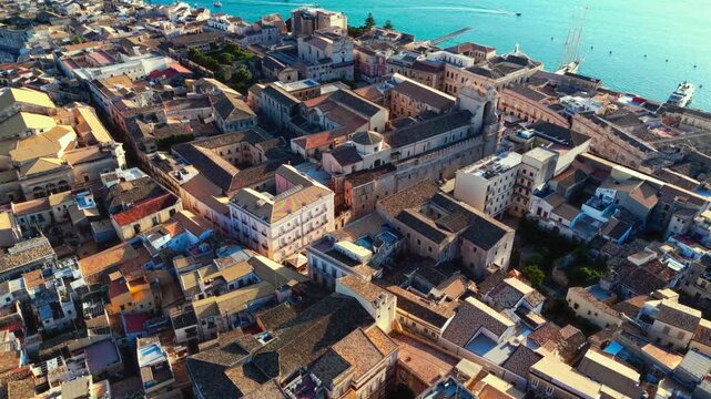 Ortygia is a small island forming the historic heart of Syracuse, Sicily. Famous for 2,700 years of rich history, it features ancient Greek ruins, Baroque architecture, and Ionian Sea views