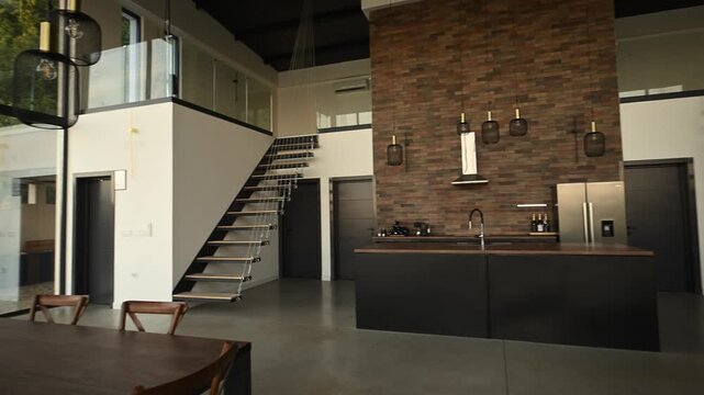 Modern loft apartment with open plan kitchen, dining area, mezzanine level, and elegant industrial design interior