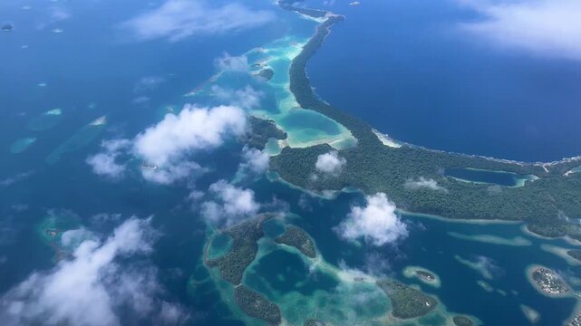Aerial drone shot over Lau Lagoon and artificial reef island villages, Malaita Province, Solomon Islands - 4K