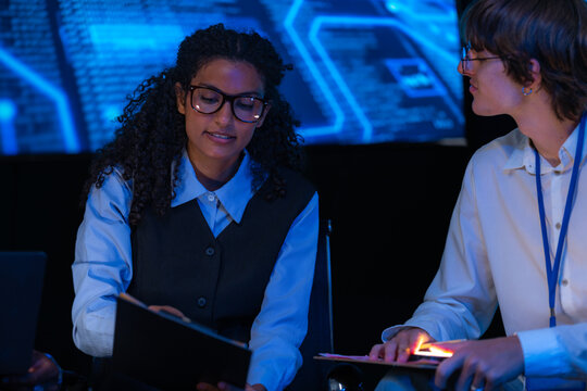 Cinematic shot of a diverse, multiethnic software team take part in the project talk in a modern technology office bathed in blue light, capturing collaboration on an inclusive (frame 819)
