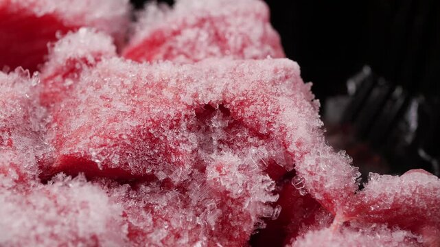 Frozen meat packed in ice at a grocery store in the afternoon