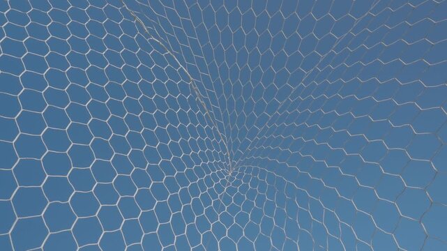 White synthetic football goal net with a hexagonal mesh pattern stands out against the azure sky.