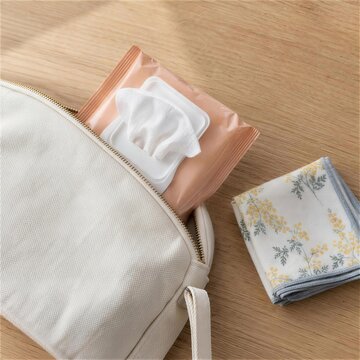 布のポーチに入れた携帯用ウェットティッシュ