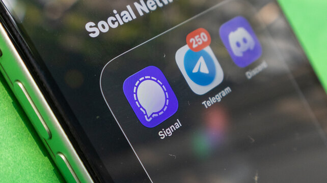 A close-up view of iphone screen showing social networking apps like signal, telegram, and discord apps.