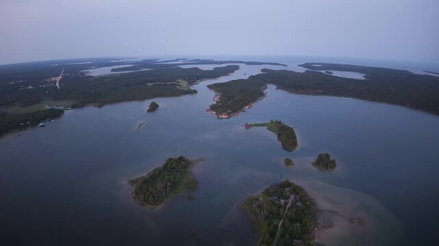 Drone panorama of wooded islands and sheltered waterways extending toward the horizon near Hessel in the Upper Peninsula of Michigan