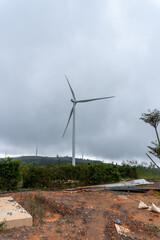Wind turbine beyond bare soil and vegetation at Cau Dat © IbragimovN