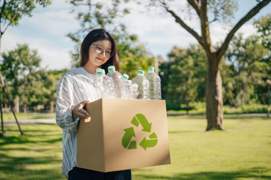 Recycle concept. woman holding a garbage box with plastic bottles with recycling symbol for environmental awareness, sustainable to zero waste reduction and Reuse.