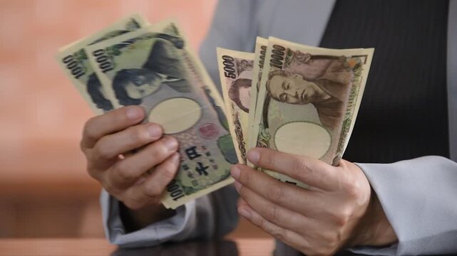 personal finances planning and household finances concept. woman is counting yen money.
