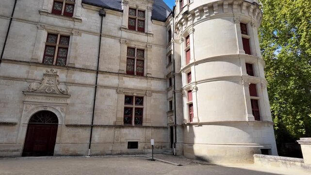 French chateau architecture at Azay-le-Rideau featuring tall roofs, rounded corner towers and detailed limestone facades.