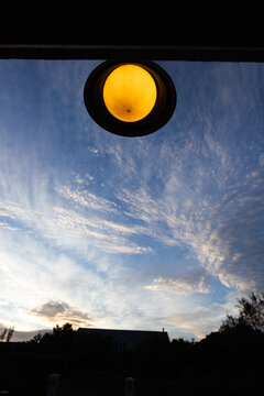 graphic image of overhead front door lamp and sunrise clouds