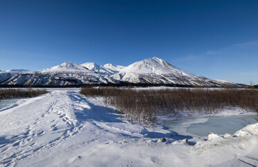 Footprints in snow on path in Alaska © Kari