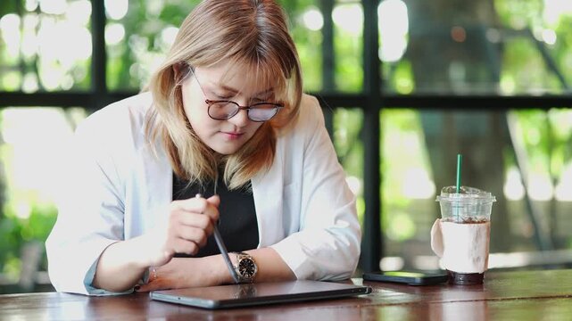 Female Executive Planning Work on Tablet at Cafe