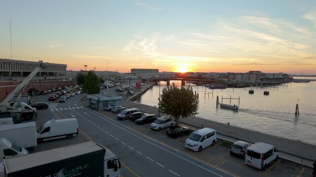 Venice waterfront road and lagoon beside industrial buildings