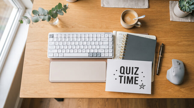 Computer keyboard next to open notepad bearing printed words quiz time placed on wooden desk beside coffee cup and grey wireless mouse