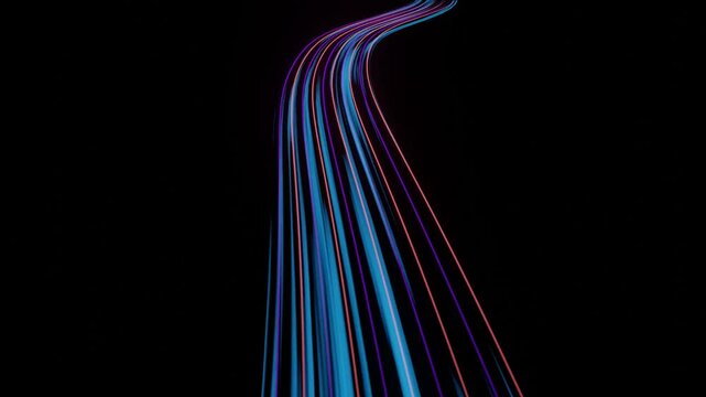 Glowing blue and pink light trails streaking forward along a curving path on black background