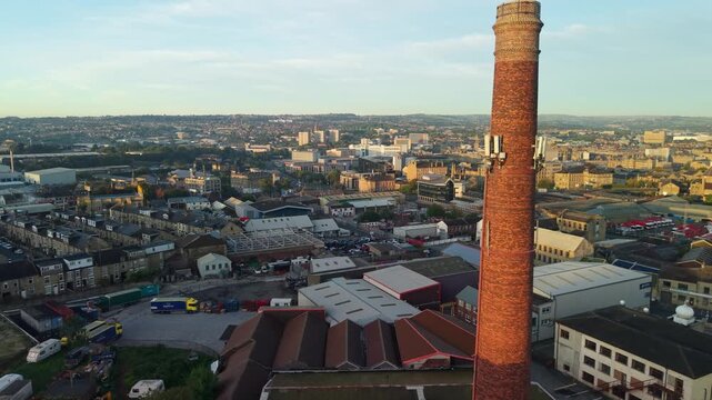 Aerial scenic view of Bradford City Hall and surroundings within city centre, architecture, roads, neighbourhoods, moving cars in sunrise. Drone POV exploration of West Yorkshire county, England, UK.
