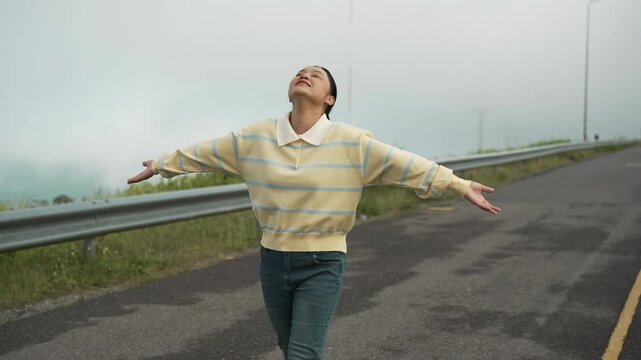 woman walking on a road on mountain in the morning