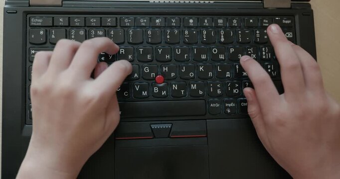 Close-up children's hands typing on laptop computer keyboard. 4K 10-bit