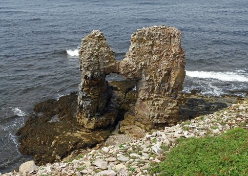 kissing rocks sea arch  rock formation and crashing waves at jerry's nose near sheaves cove in summer on  west coast of the port au port peninsula  in st. george's bay in western newfoundland, canada