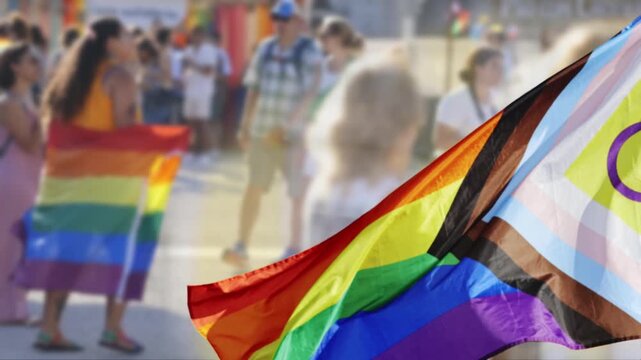 Progress pride flag waving during an lgbtqia parade celebration