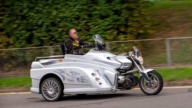 Milton Keynes,Bucks,UK - Aug 3rd 2025:  Martin Conquest The Conquest tricycle designed for wheelchair users with access via a rear ramp travelling on a British road